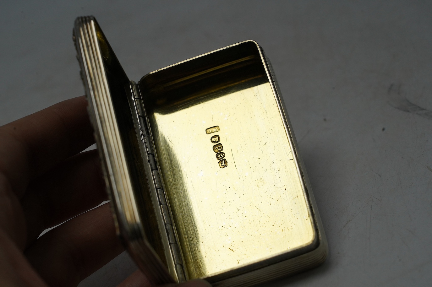 A late George III engine turned silver snuff box, William Elliot, London, 1819, 74mm, with interior engraved inscription. Condition - fair to good